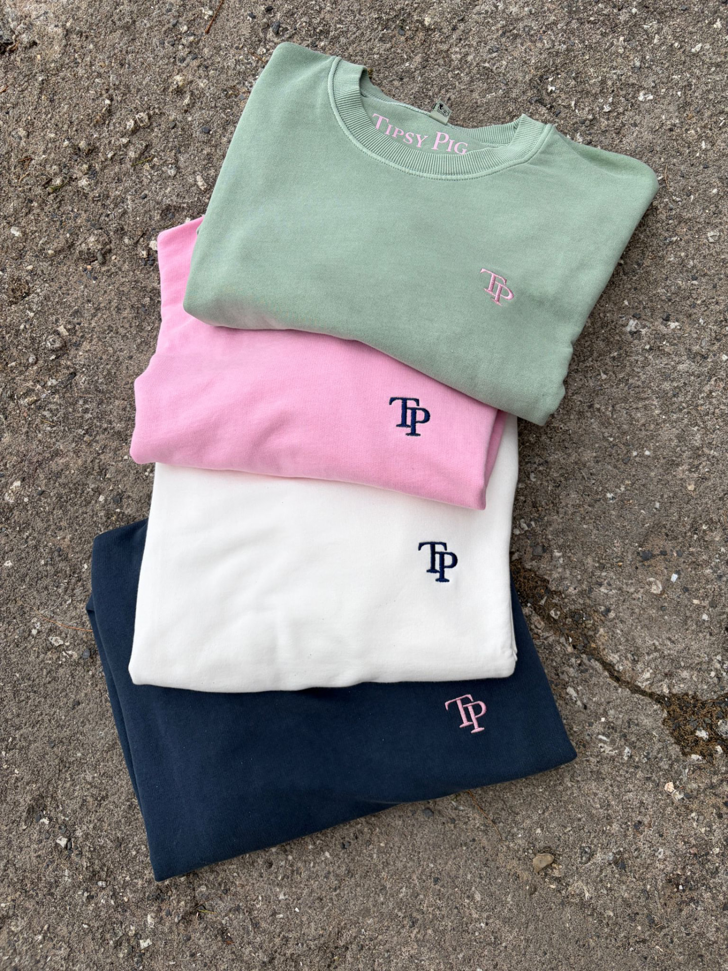 The Pig Wash Collection sweatshirts in sage, pink, white and navy